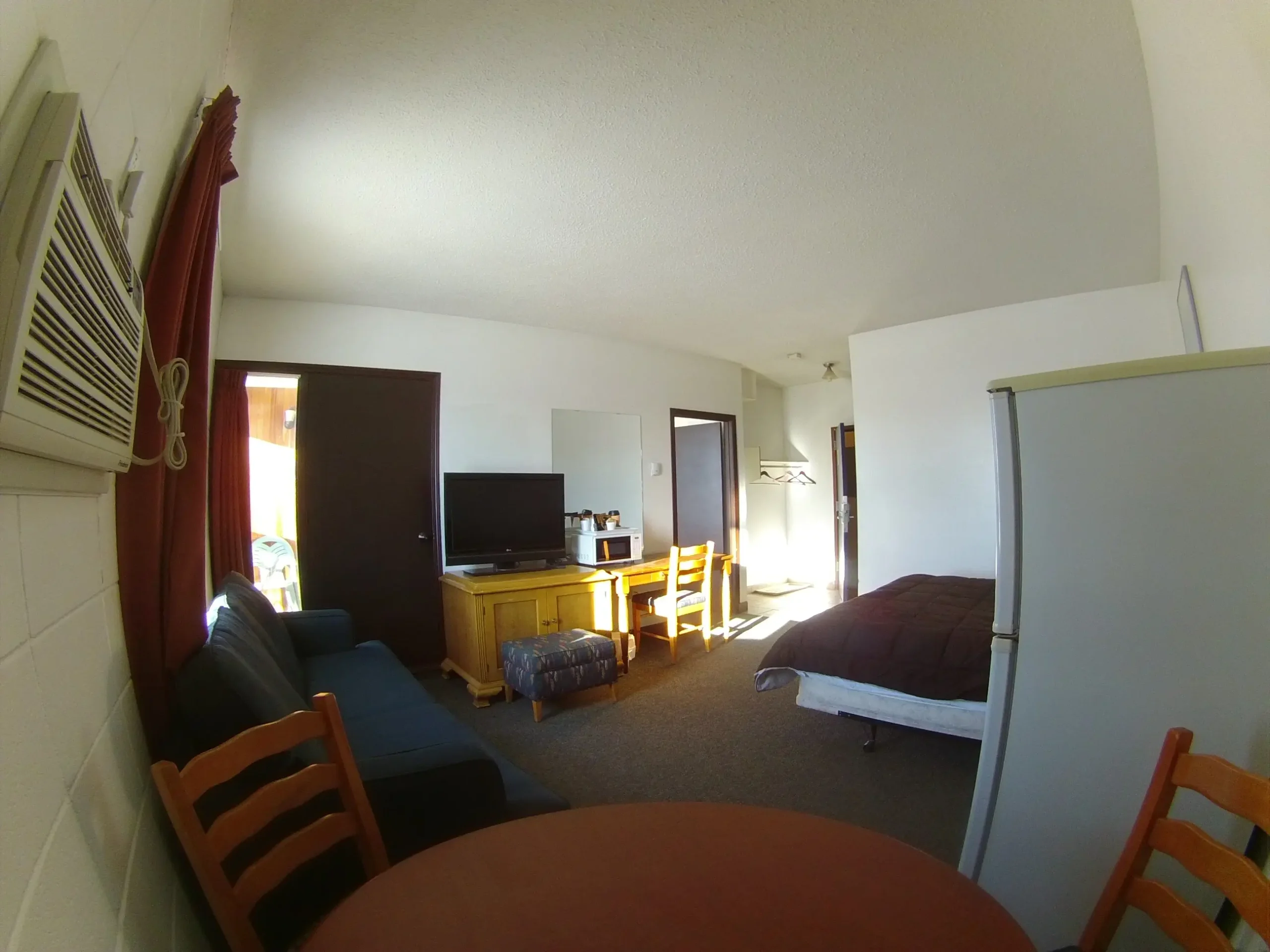 Bedroom suite with refrigerator and couch