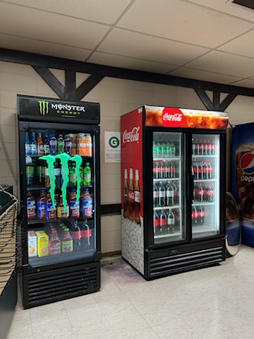 Monster Energy and Coca-Cola fridges in a convenience store
