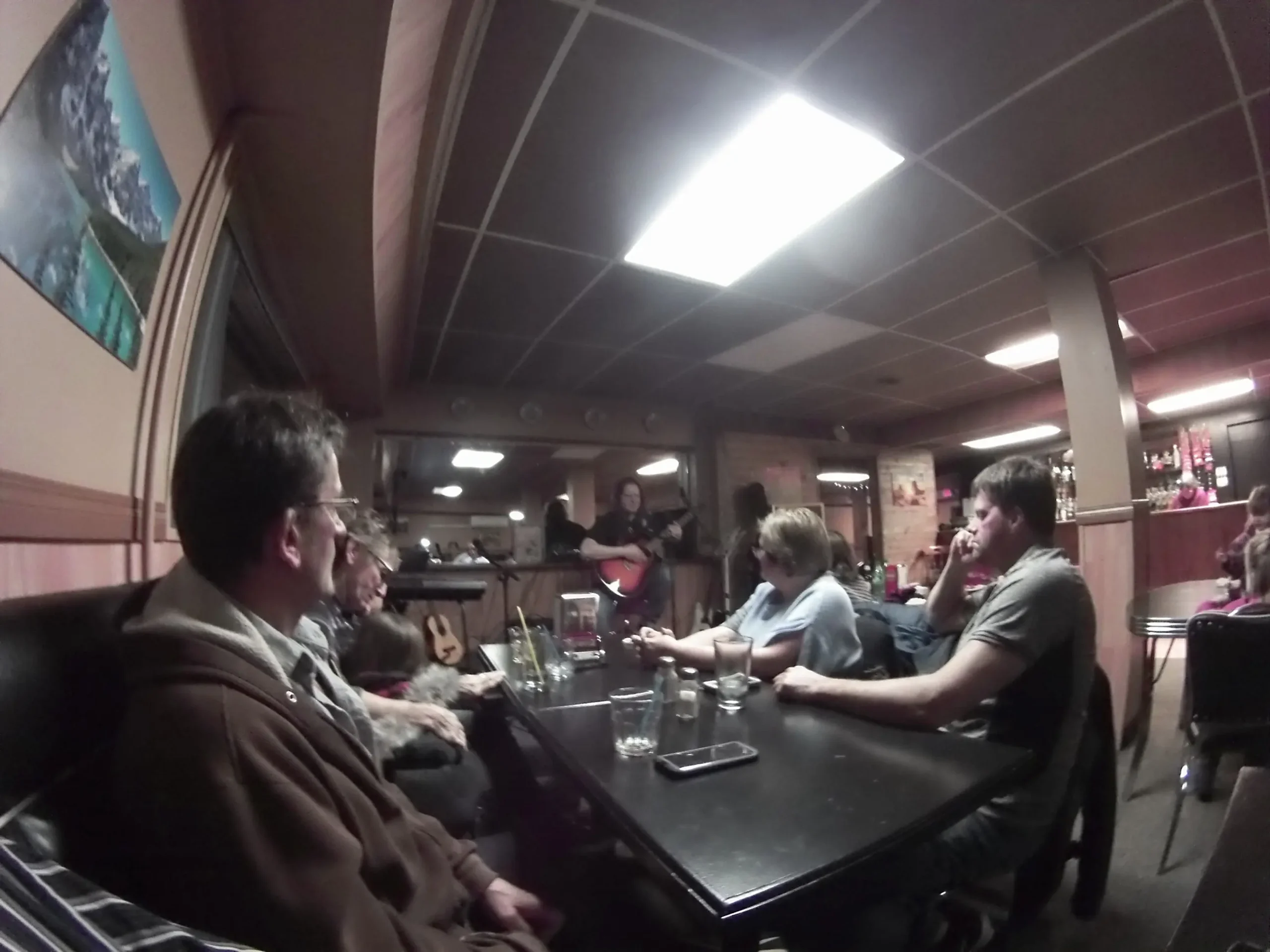 People sitting at a table in a dimly lit bar